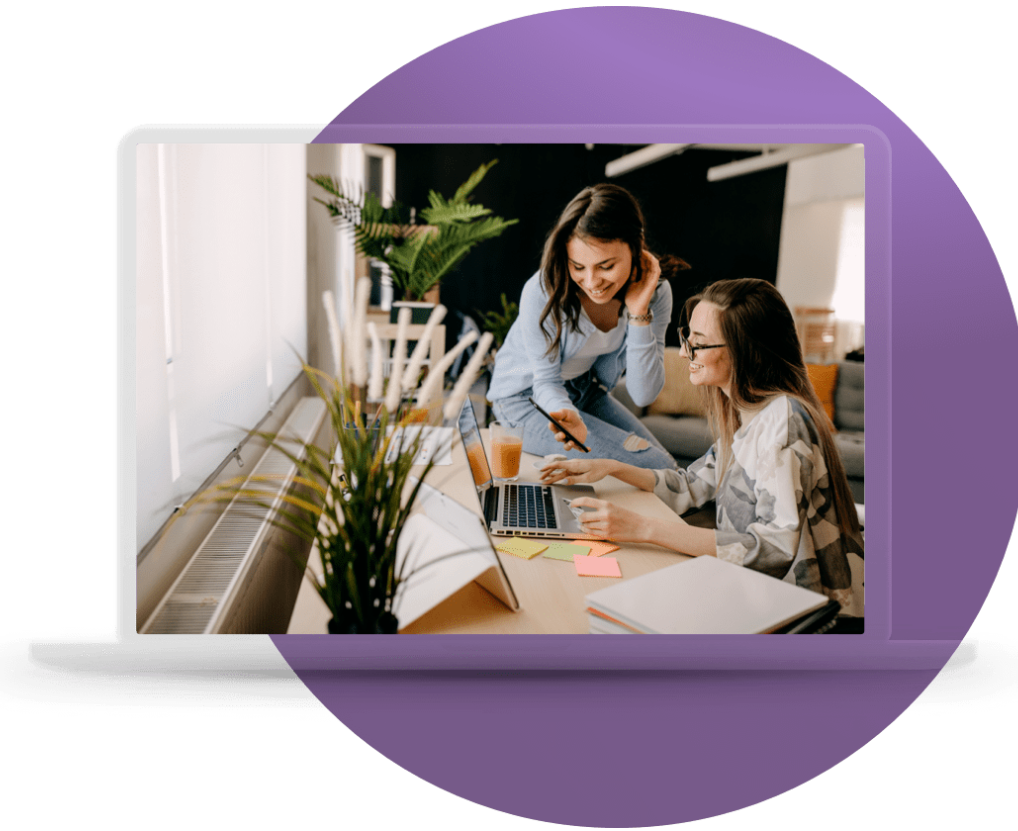 Two AICD members reviewing the member portal on a laptop