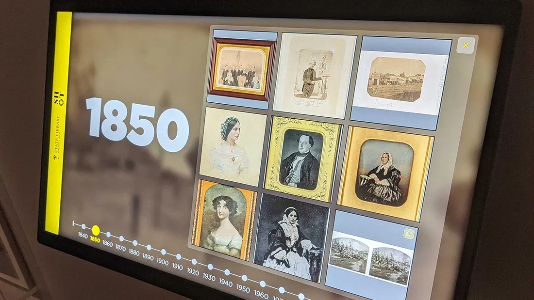 The kiosk interface showing the 1850 decade grid above a scrollable timeline