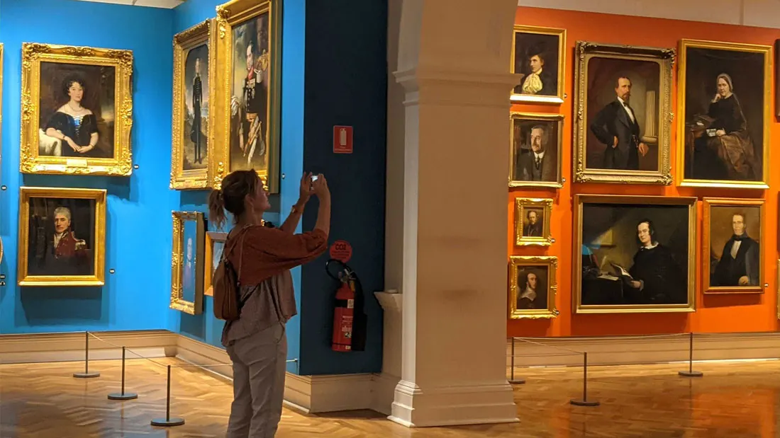 A visitor photographing works in the portrait gallery