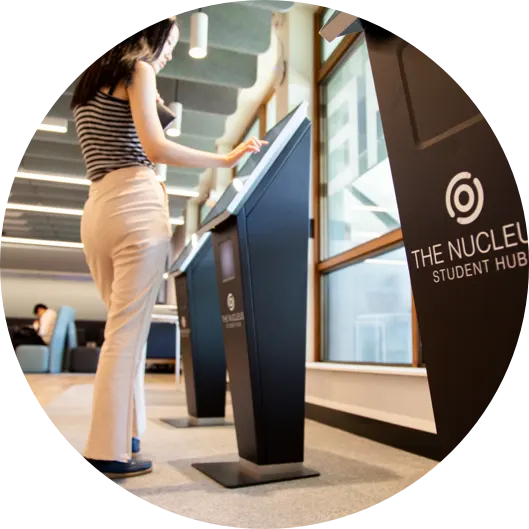 A student using a Nucleus Student Hub self-service kiosk at UNSW