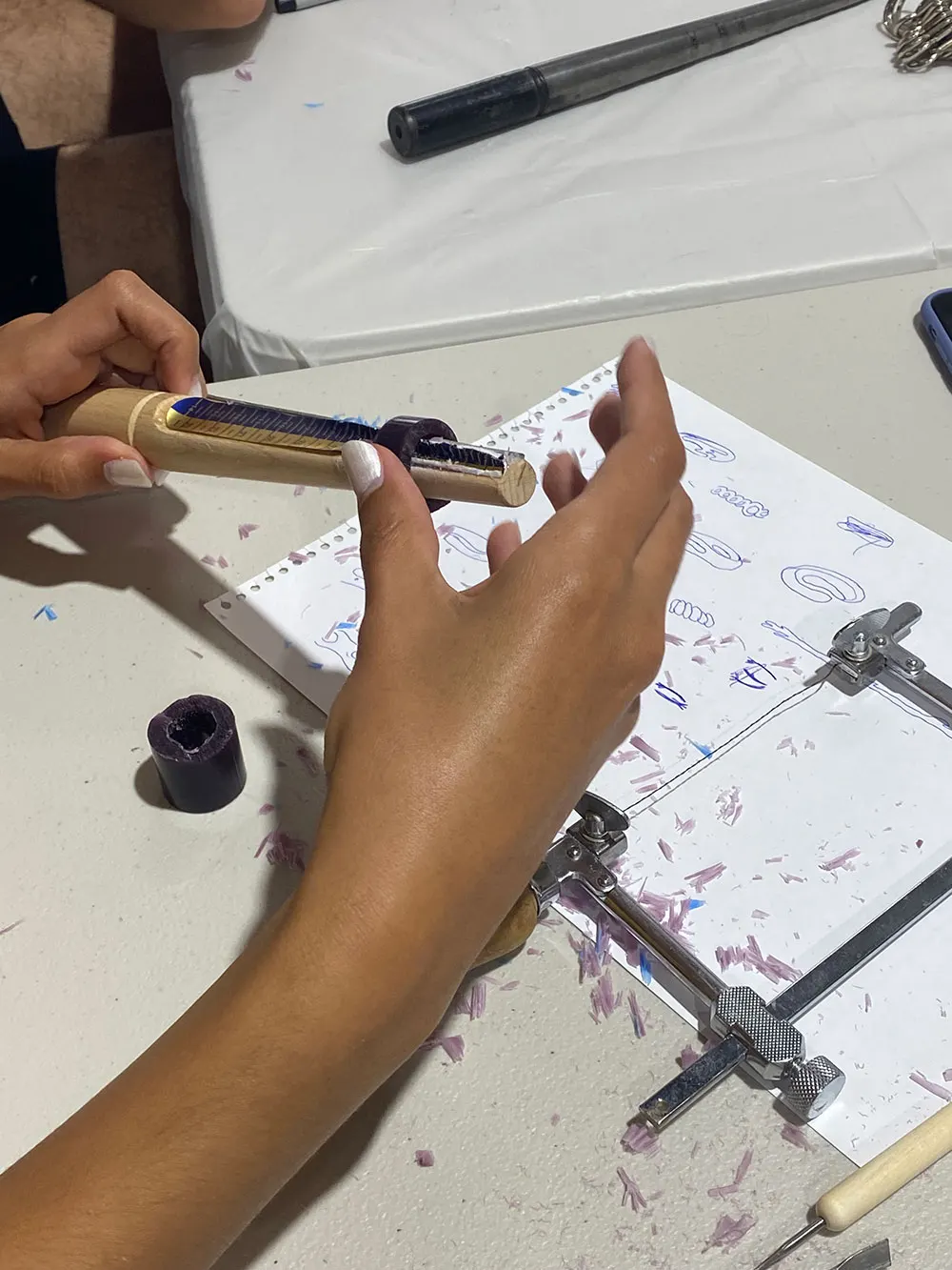 Hands filing a ring at the workshop bench